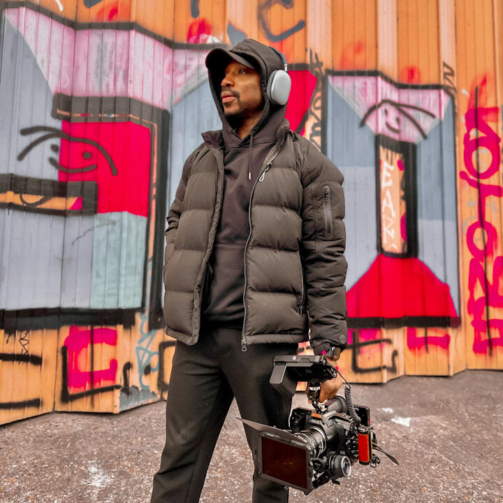 Video editor Tunde Arowojolu wearing headphones — Jolu Post remote post-production studio, West London